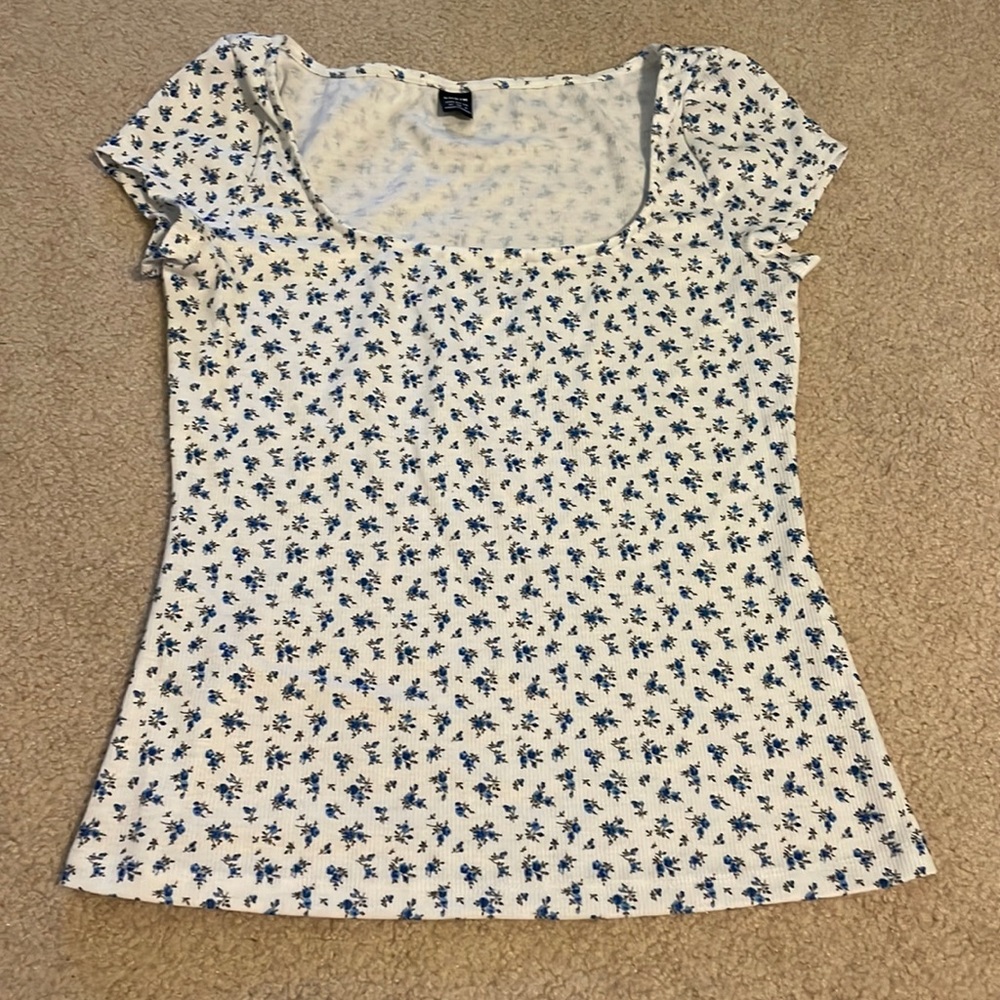 White with blue floral v-neck shirt